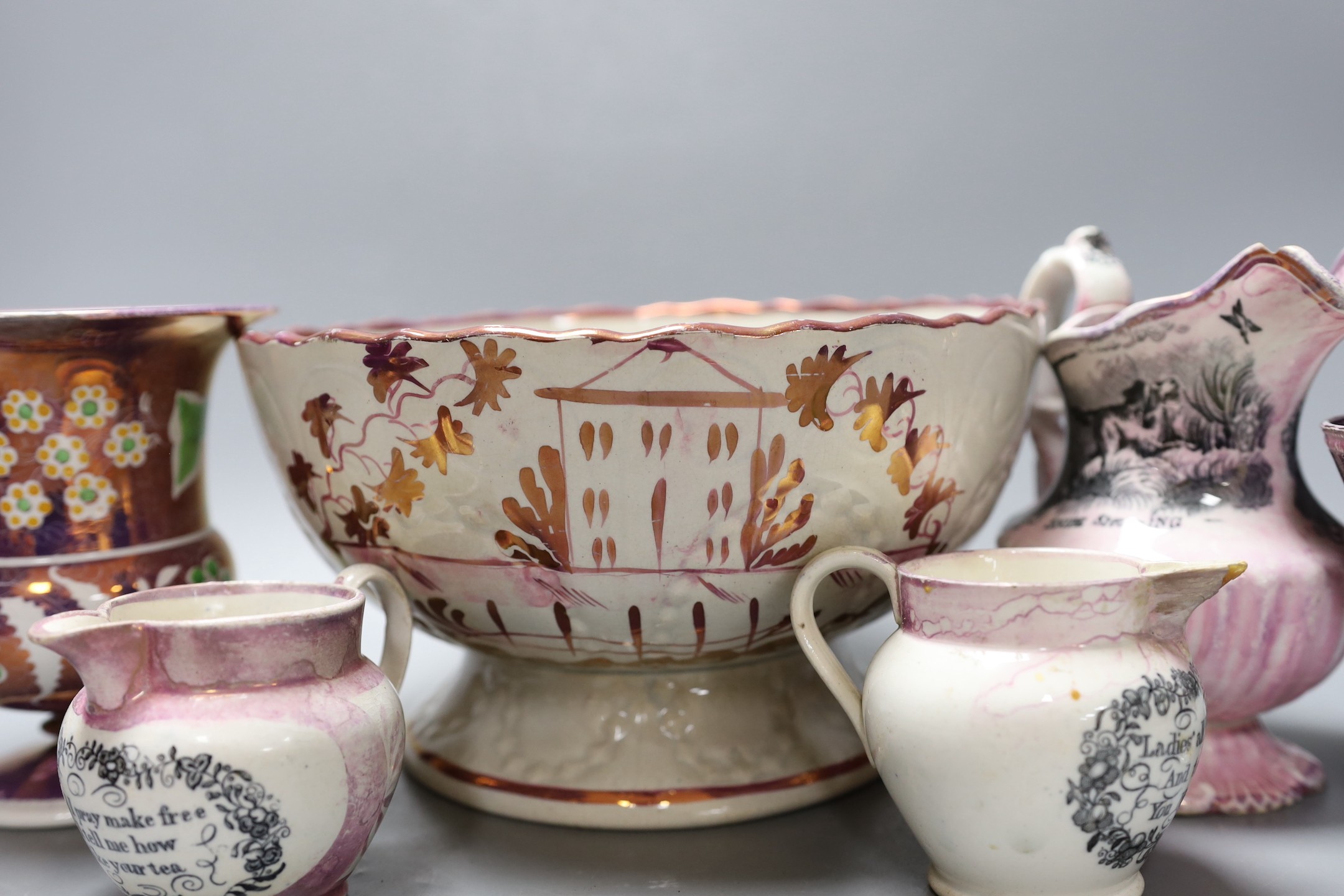 A group of early 19th century pink lustre vases and jugs and a junket bowl